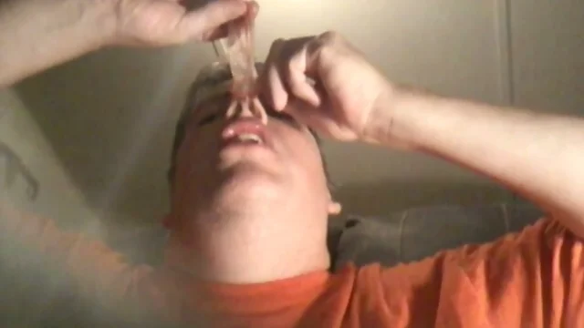 Cum filled condom in a faggots mouth