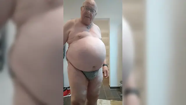 Fat crossdresser poses in sexy leopard slip