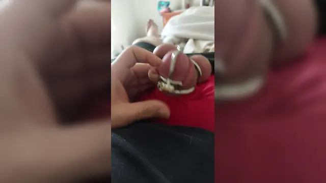 Boy in bondage chastity cage cumming while in permanent ball squeezing chastity