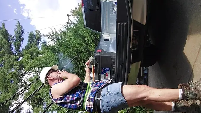 Construction bear taking a break, smoking a hot cigar outdoors