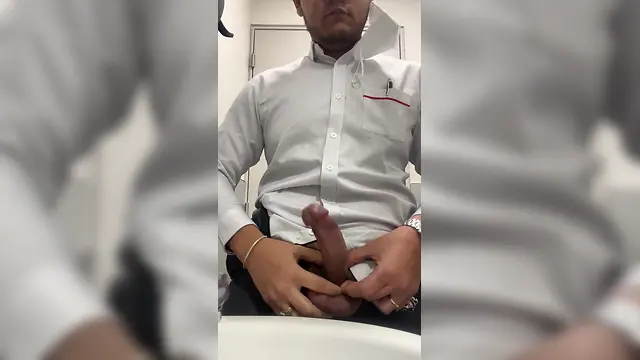 Man masturbating in office bathroom