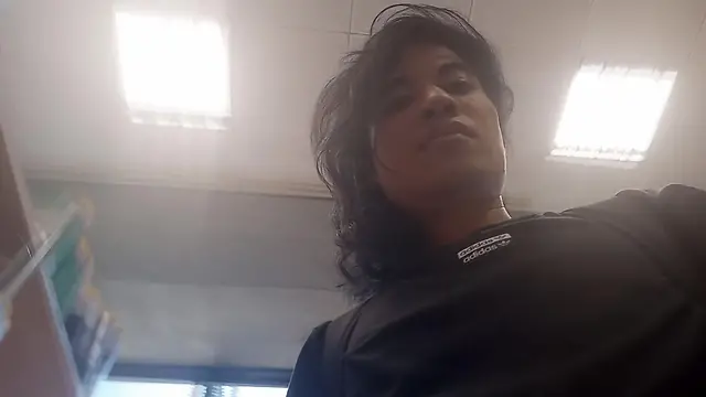 College student performs seductive dance and striptease on teachers desk in classroom